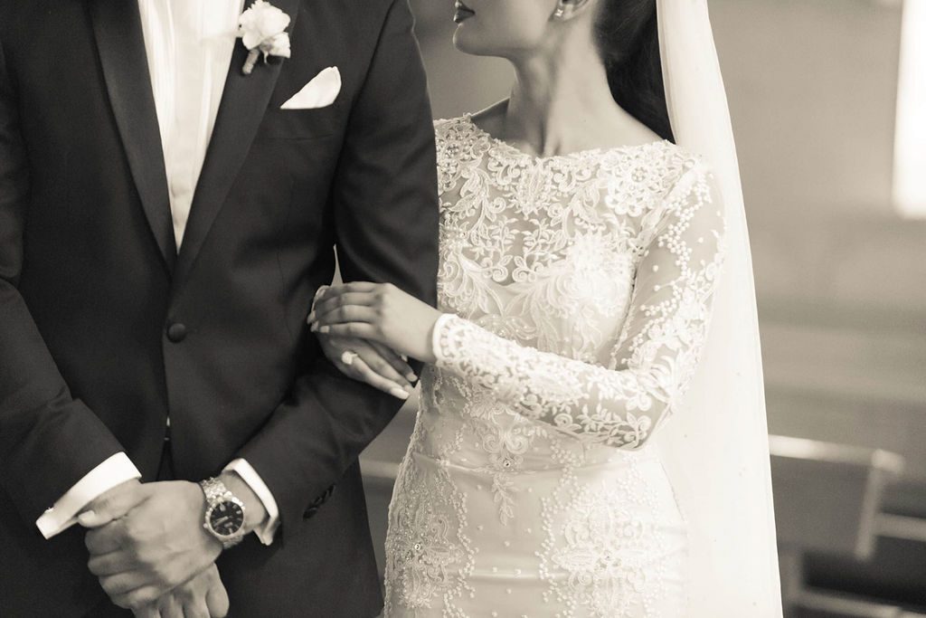groom adjusting tie getting ready for his wedding