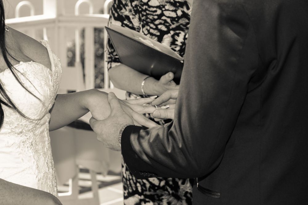 groom putting on ring at Panorama house