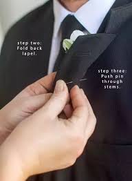 Inserting pin from behind lapel