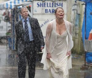 bride crying as it rains on her wedding day