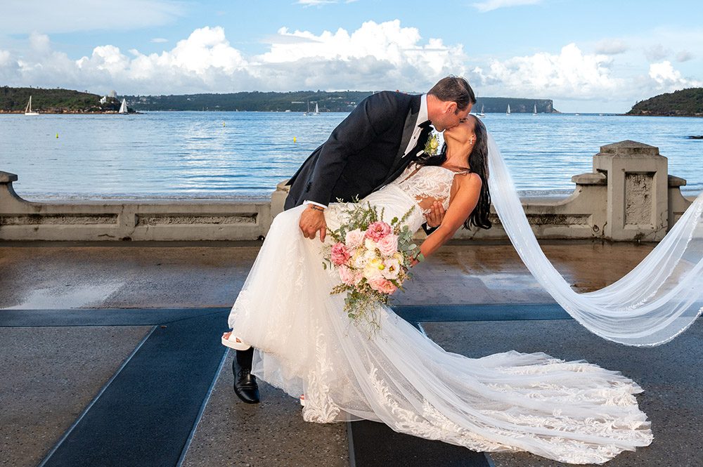 Sydney Harbour wedding photographer with bride and groom dip kissing