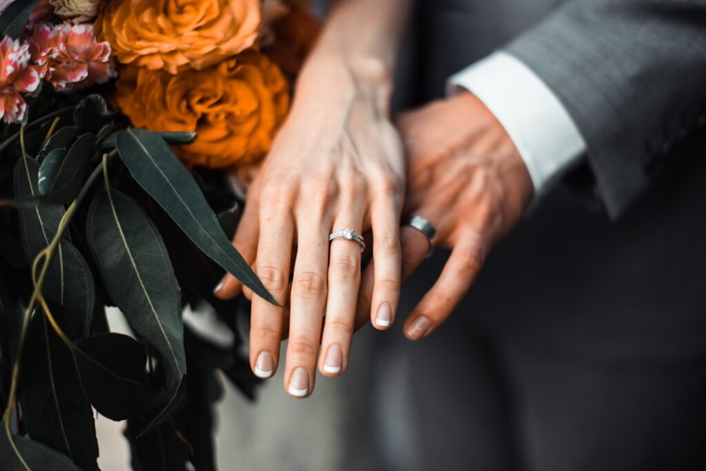 wedding rings with couple holding hands