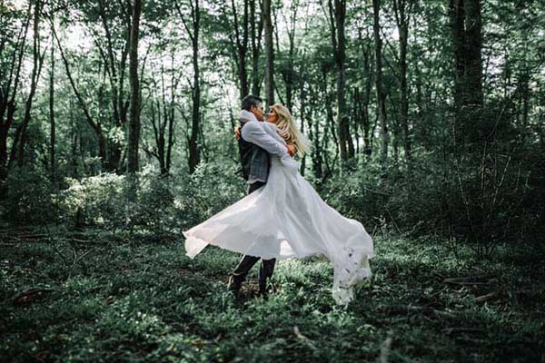 couple dancing in the forest on their wedding day