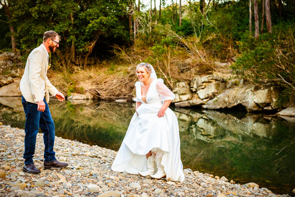 Bride having fun by the river